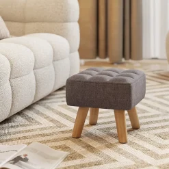 Pouf repose-pieds style nordique piètement bois incliné tissu assise effet capitonné gris